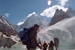 03 Porter Muhammad Khan Crossing A Small River On The Upper Baltoro Glacier With Gasherbrum IV Behind